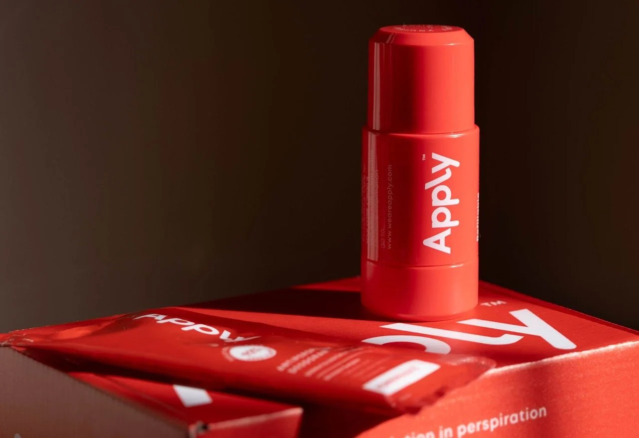 An Apply roll-on standing on its packaging