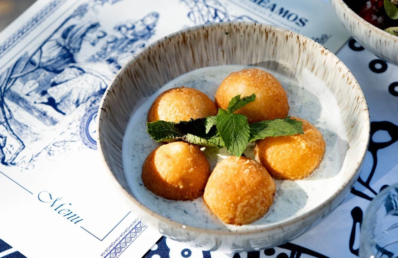 Golden fried balls in a creamy sauce with mint, on the Geamos menu