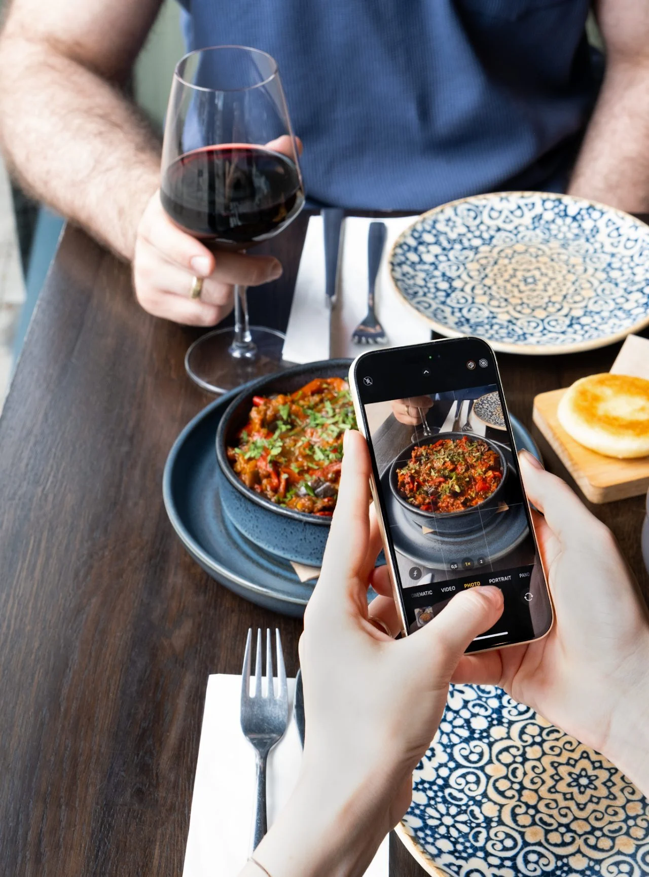 A guest photographs a Georgian dish at Gurmani with a phone