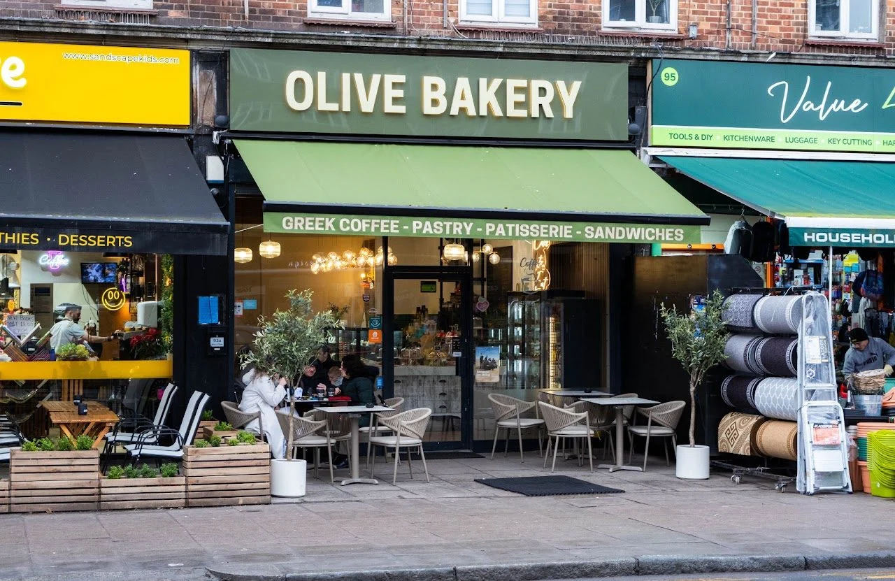 The Olive Bakery's shopfront, with tables on the pavement